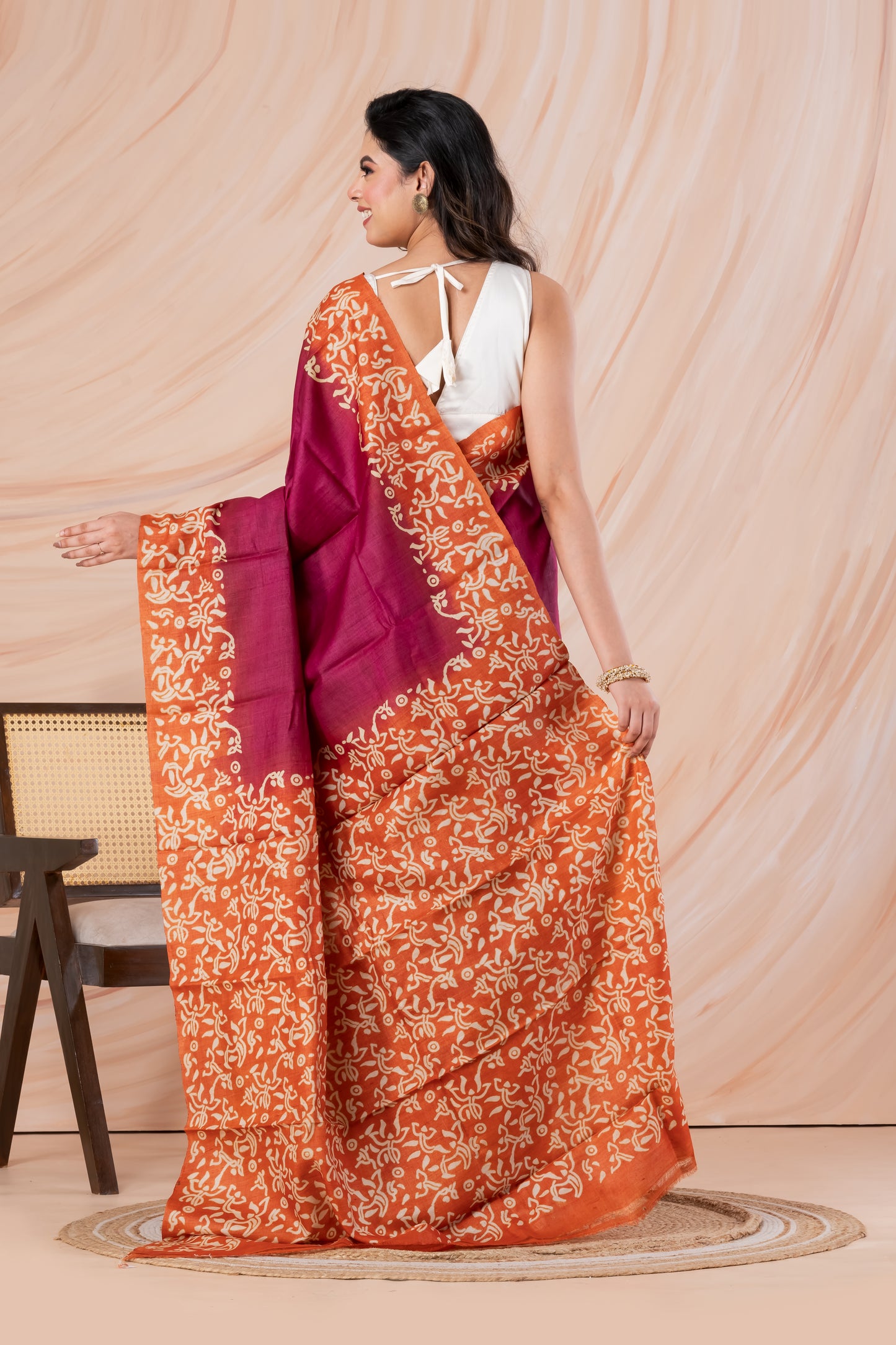 Deep pink with orange border tussar printed saree.