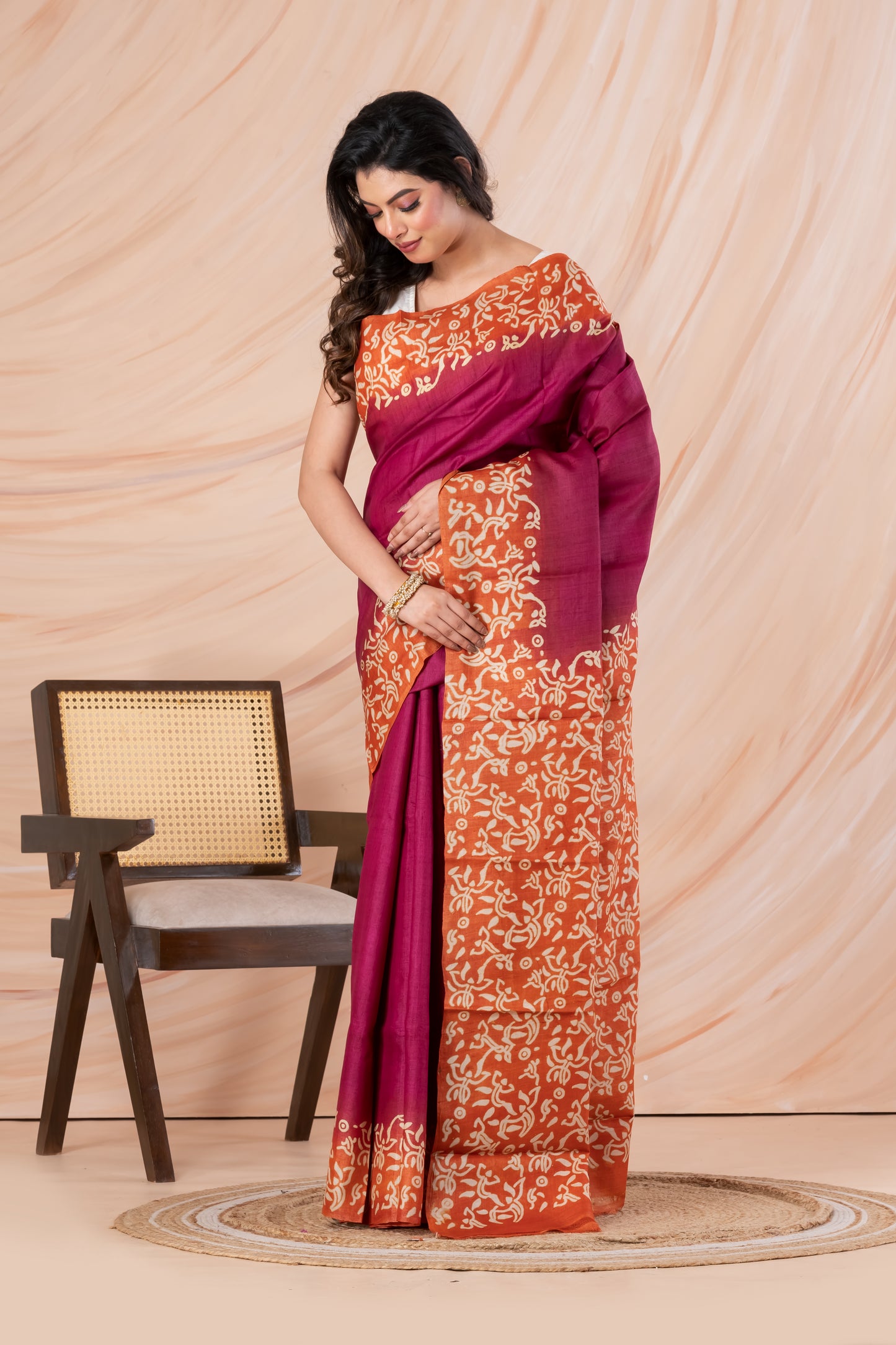 Deep pink with orange border tussar printed saree.