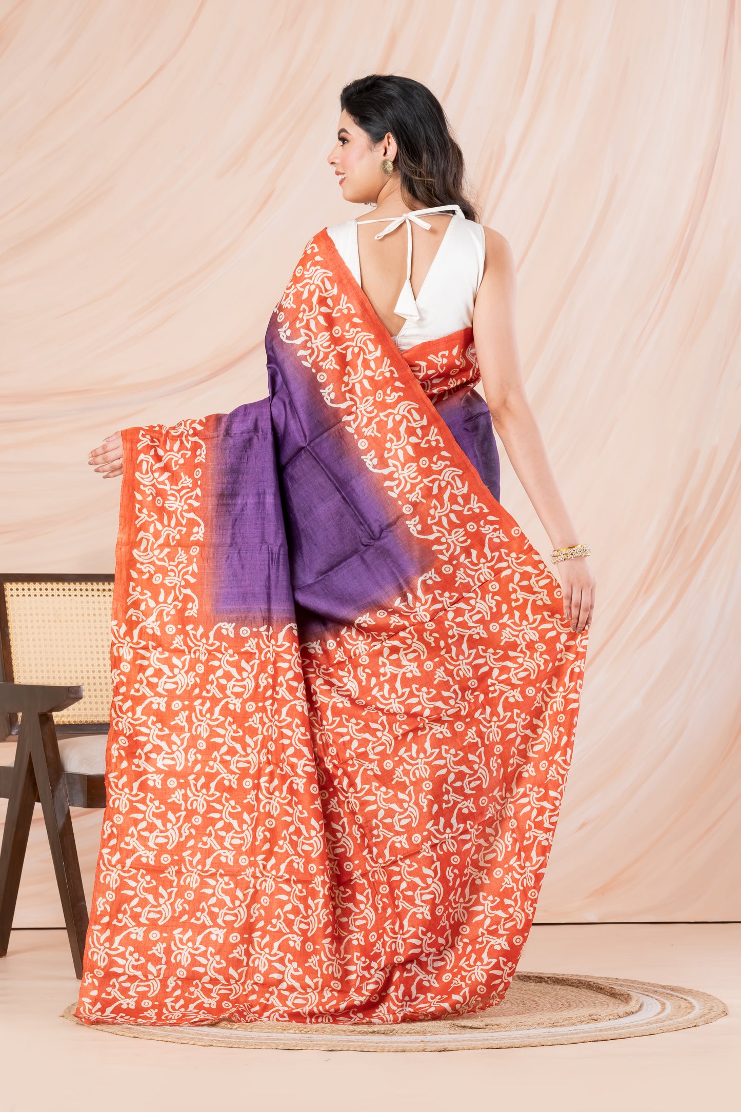 Purple body orange printed tussar saree.