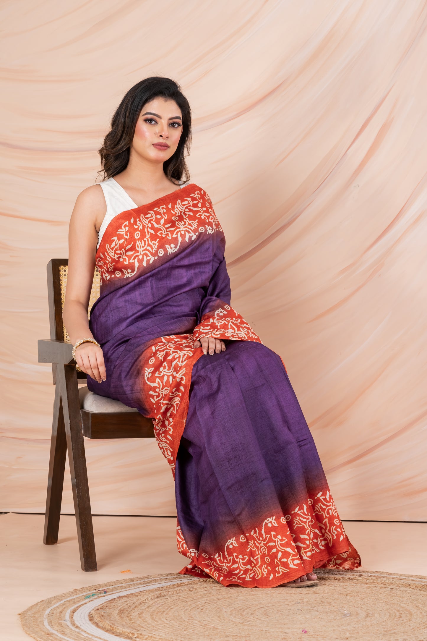 Purple body orange printed tussar saree.