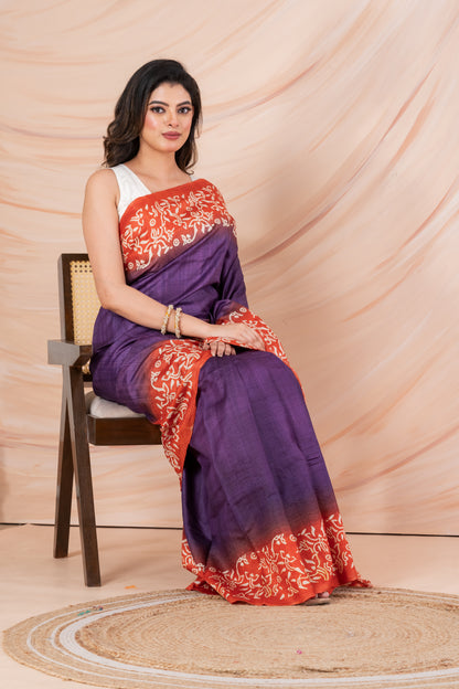 Purple body orange printed tussar saree.