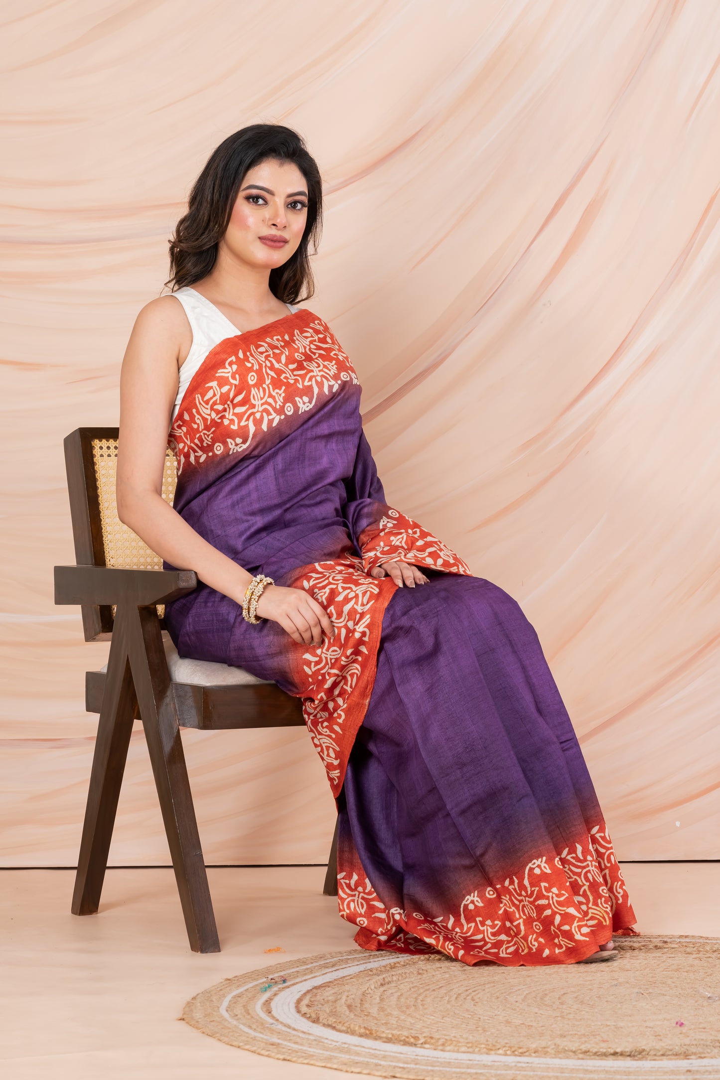 Purple body orange printed tussar saree.