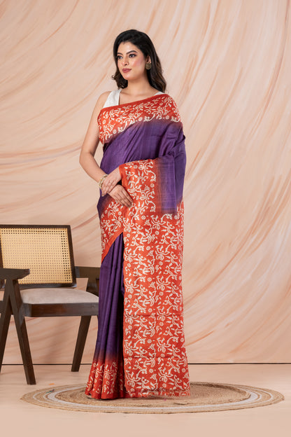 Purple body orange printed tussar saree.