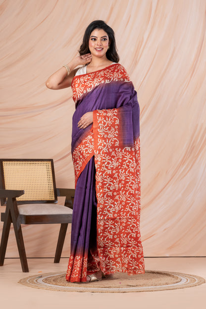 Purple body orange printed tussar saree.