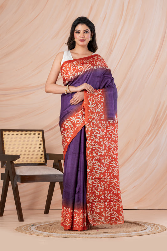 Purple body orange printed tussar saree.