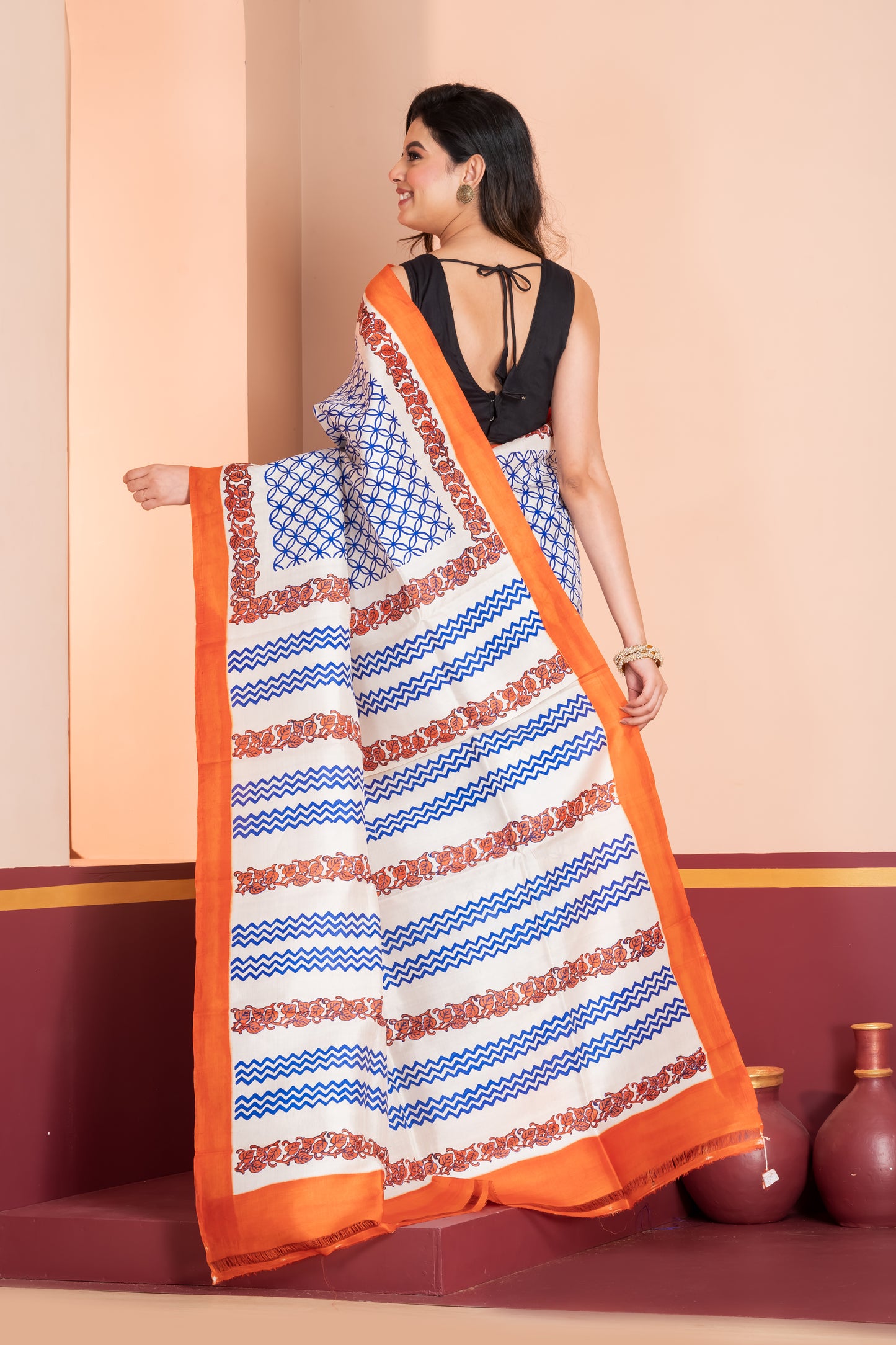 Pure printed silk with an orange border, paired with a plain orange blouse piece.