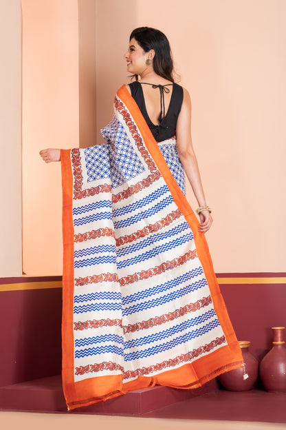 Pure printed silk with an orange border, paired with a plain orange blouse piece.