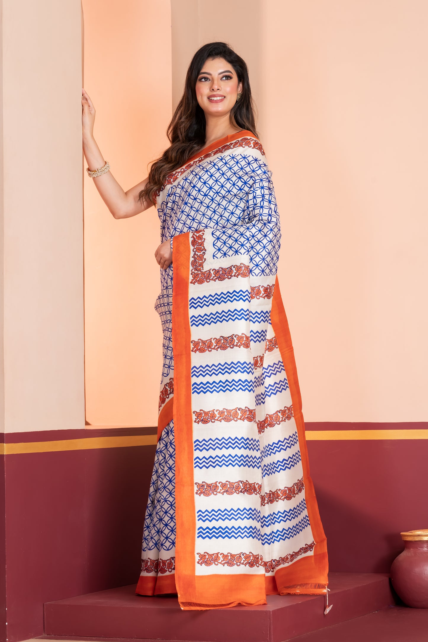 Pure printed silk with an orange border, paired with a plain orange blouse piece.