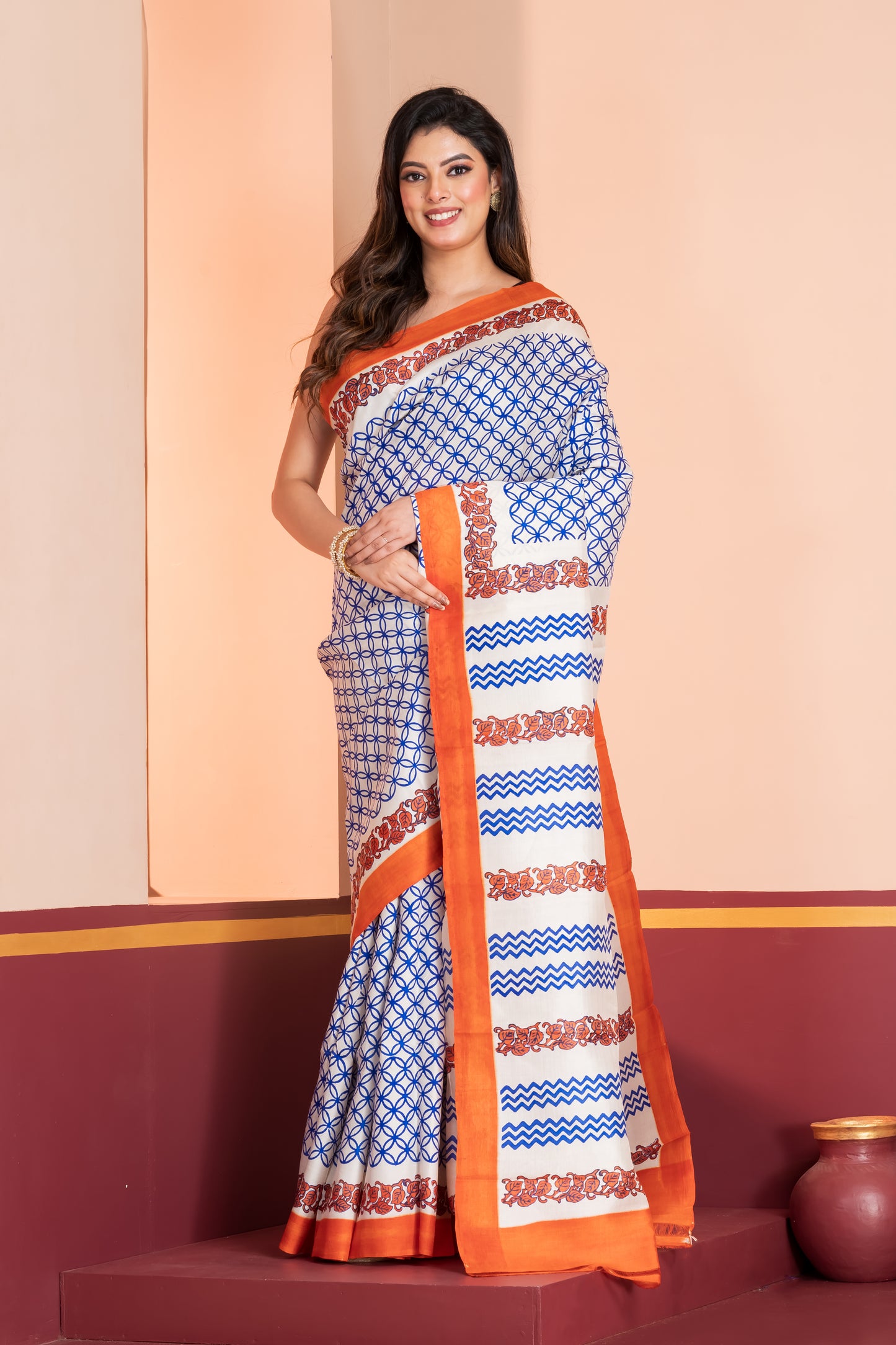 Pure printed silk with an orange border, paired with a plain orange blouse piece.