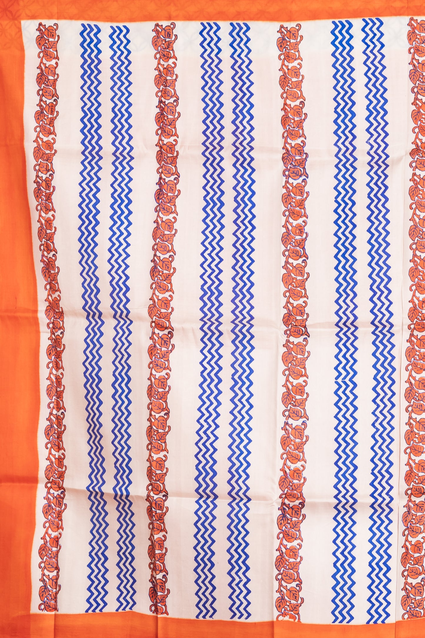 Pure printed silk with an orange border, paired with a plain orange blouse piece.