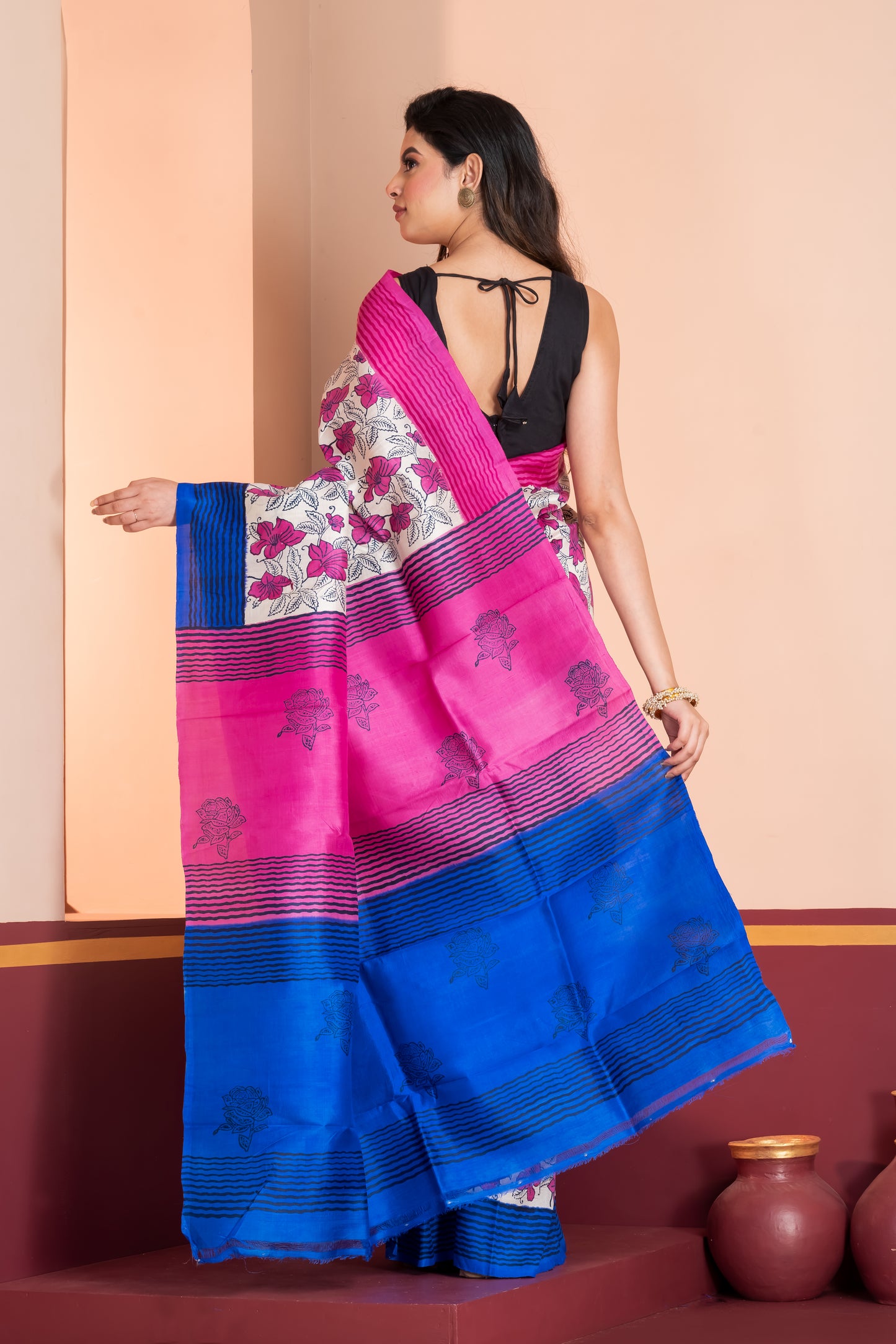 Blue and pink striped border silk saree leaf prints allover.