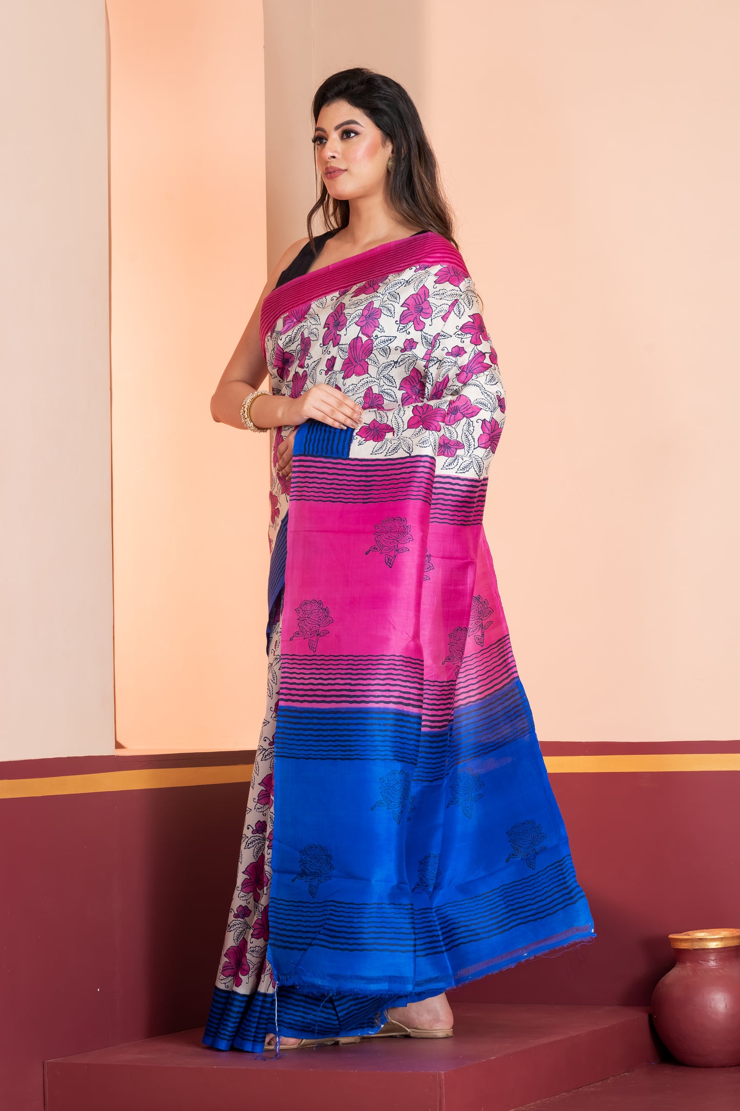 Blue and pink striped border silk saree leaf prints allover.