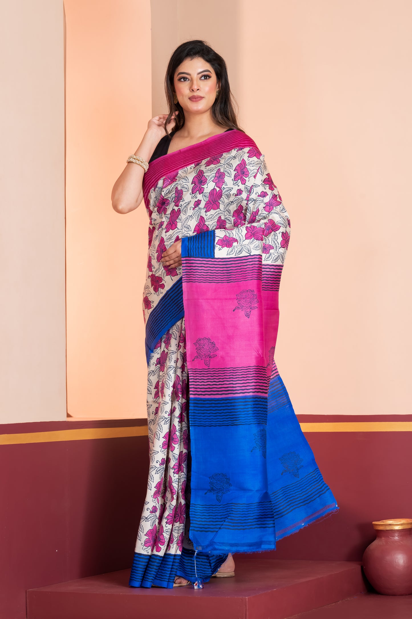 Blue and pink striped border silk saree leaf prints allover.