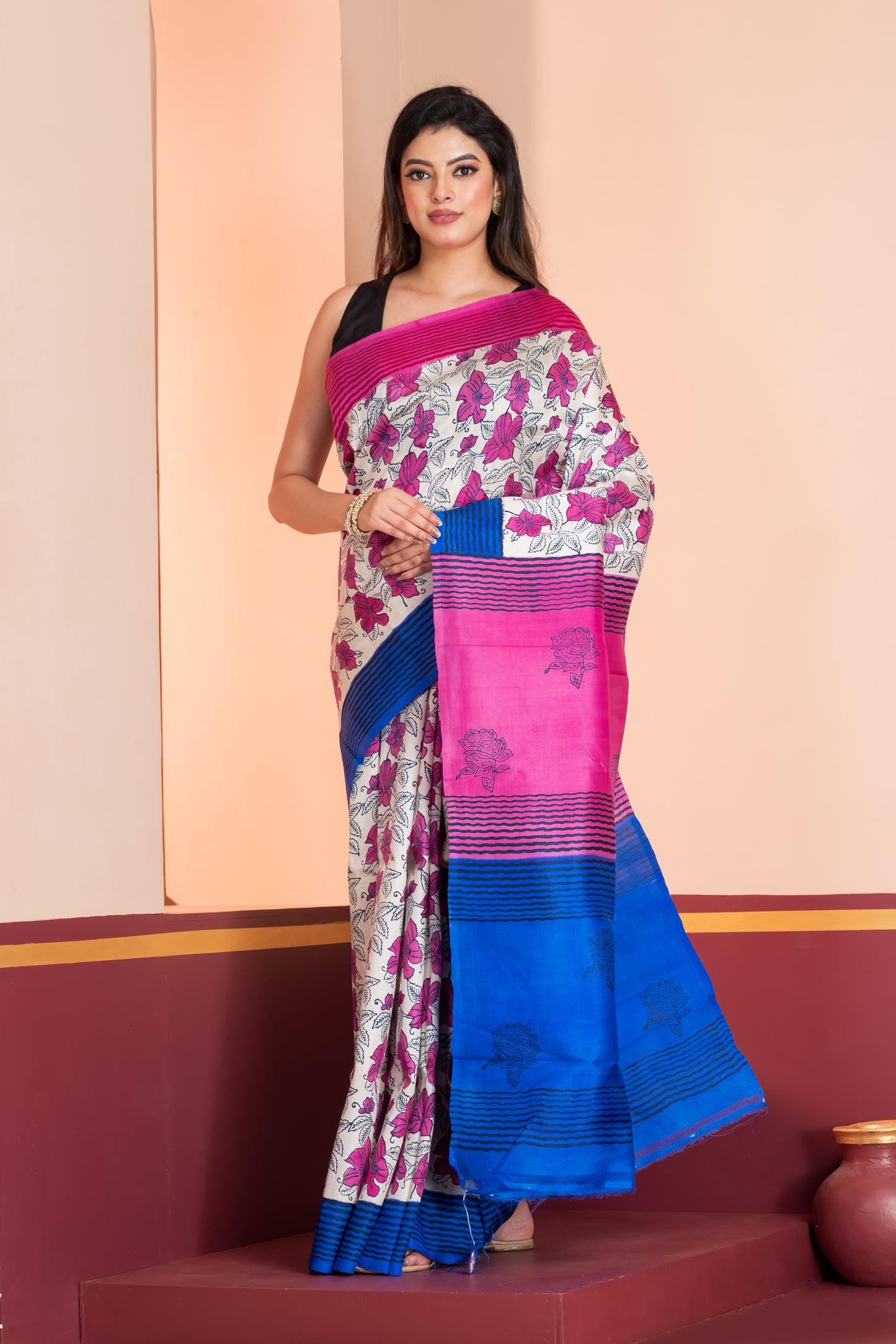 Blue and pink striped border silk saree leaf prints allover.