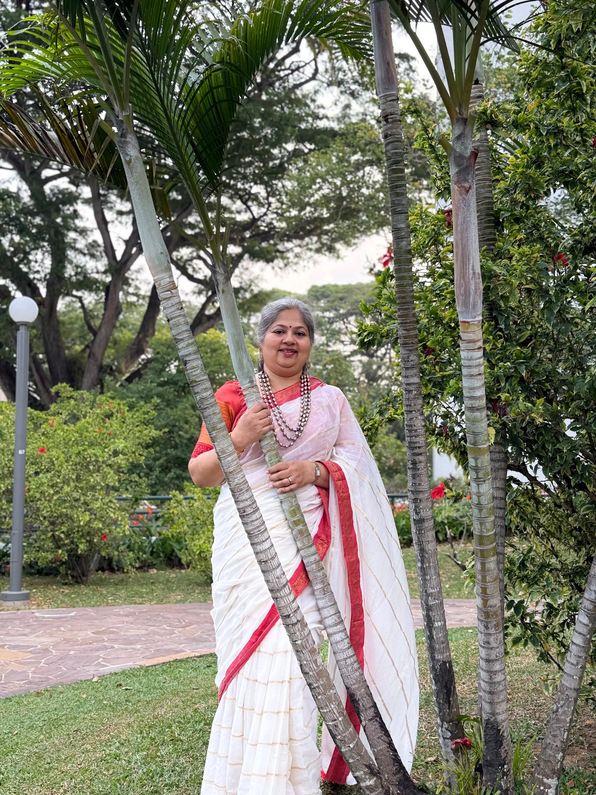 Off white red Kanchi border golden stripe saree