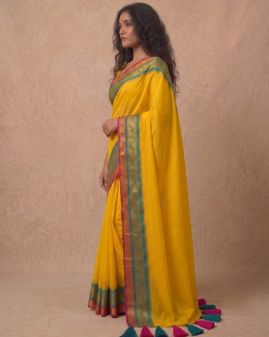 Bright yellow multi color kanchi border mulmul saree