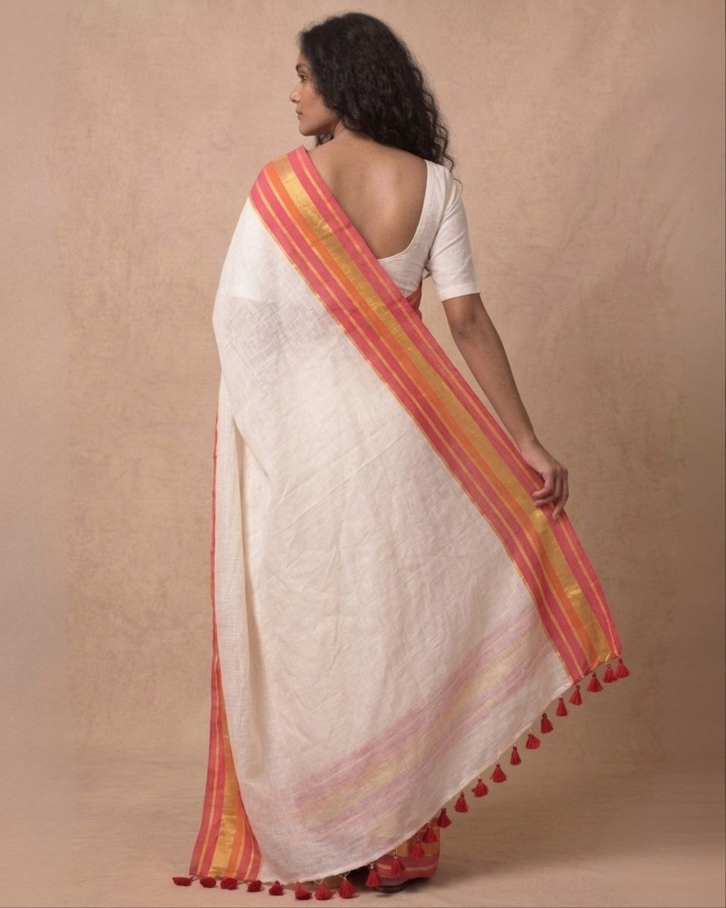 Off white red orange zari border mulmul saree