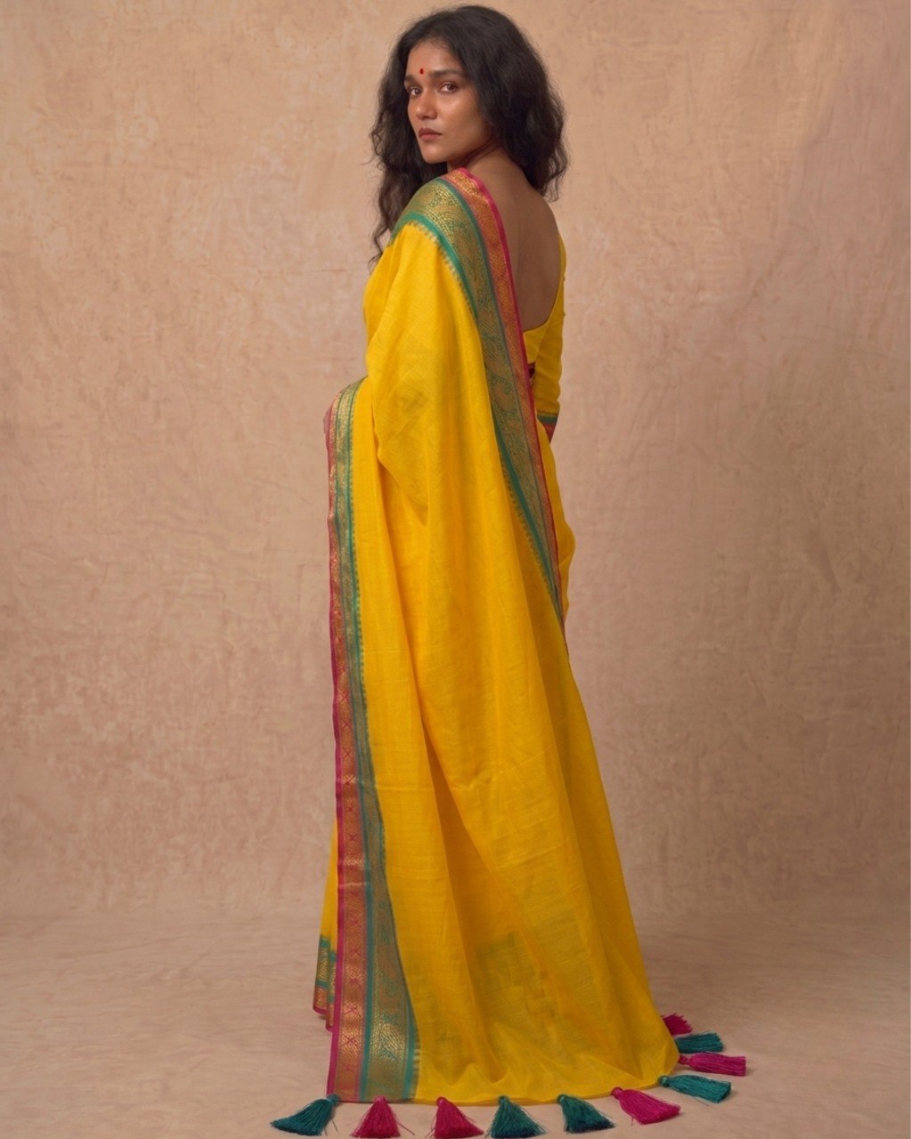 Bright yellow multi color kanchi border mulmul saree