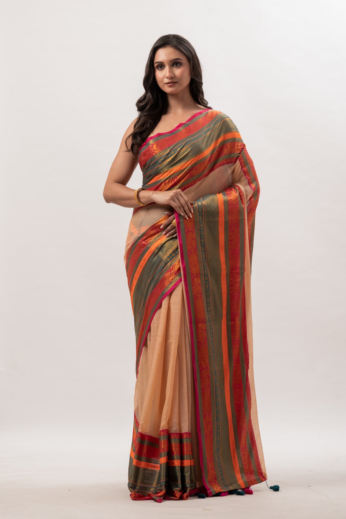 Deep beige mul cotton saree with vibrant green n orange kanchi border