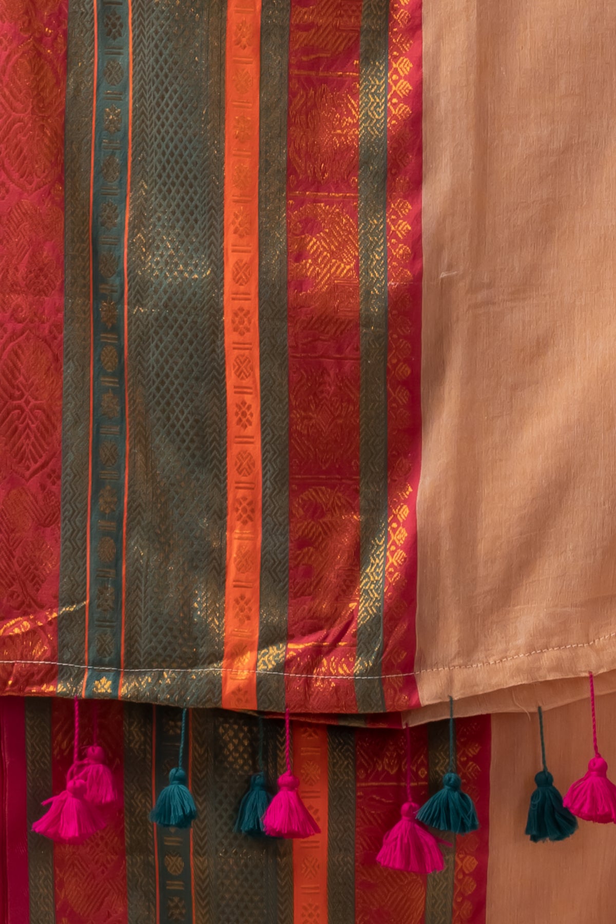 Deep beige mul cotton saree with vibrant green n orange kanchi border