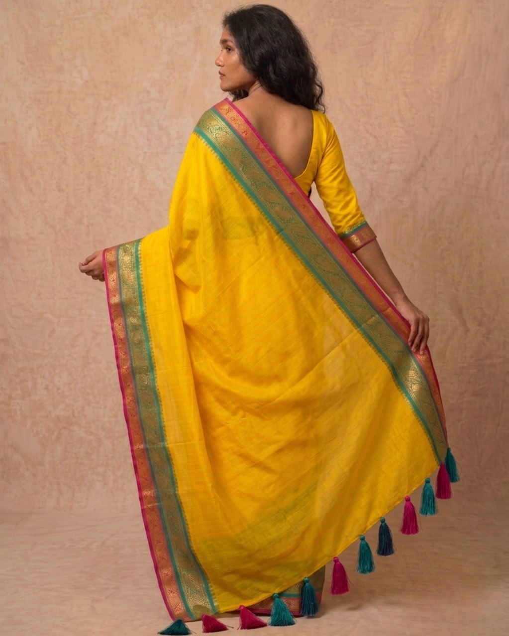 Bright yellow multi color kanchi border mulmul saree
