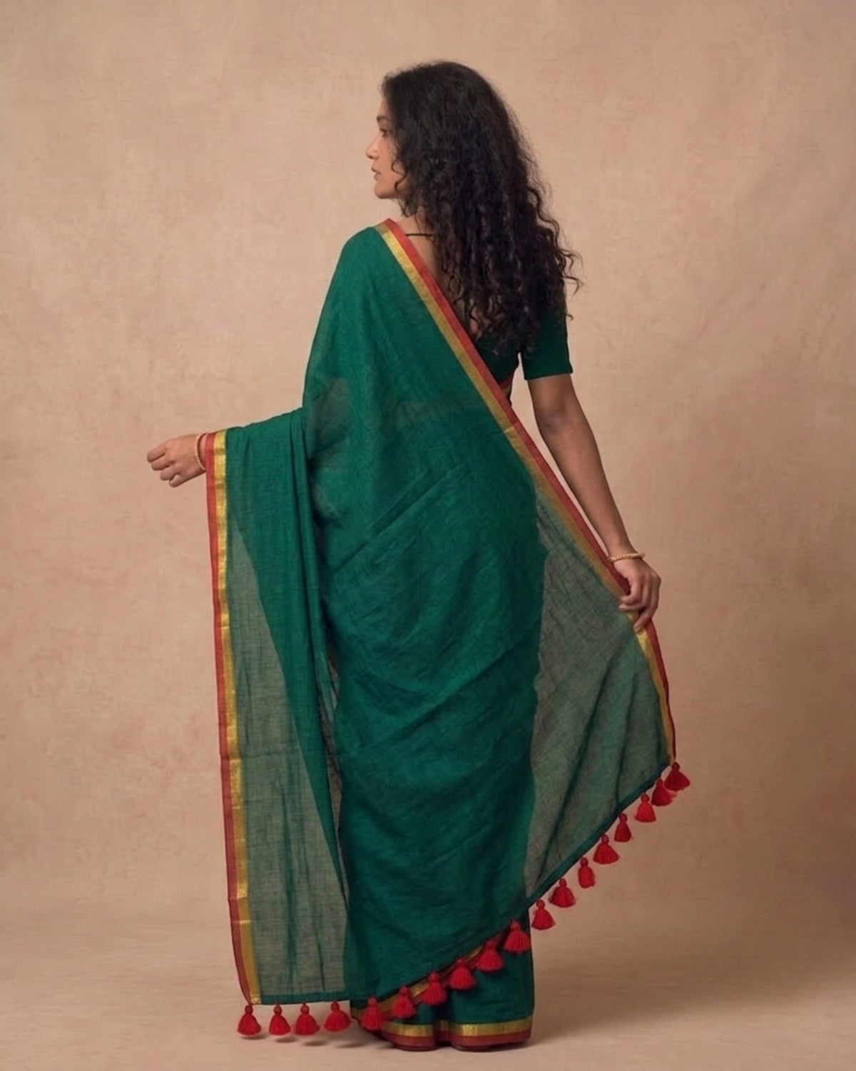 Dark green mulmul cotton saree with red n gold zari border