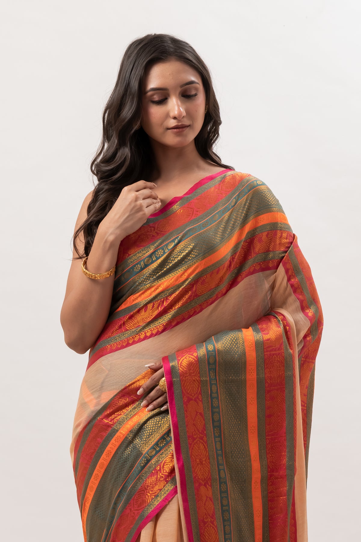 Deep beige mul cotton saree with vibrant green n orange kanchi border