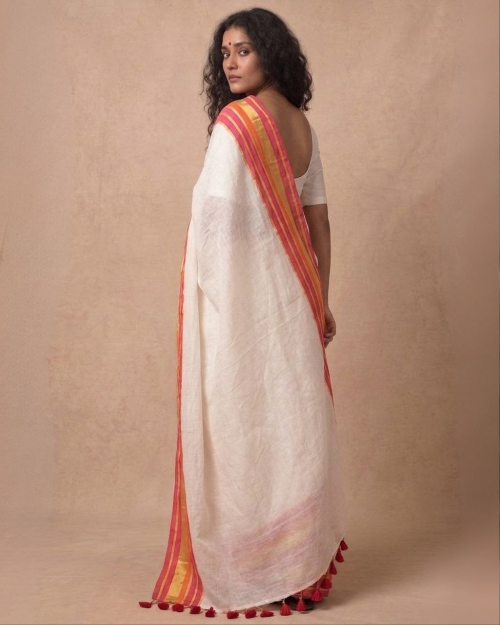 Off white red orange zari border mulmul saree